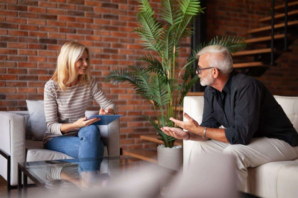 Therapist and client talking during an addiction counseling session at Capo Beach Recovery in San Juan Capistrano, California, offering compassionate support for drug and alcohol detox and recovery.