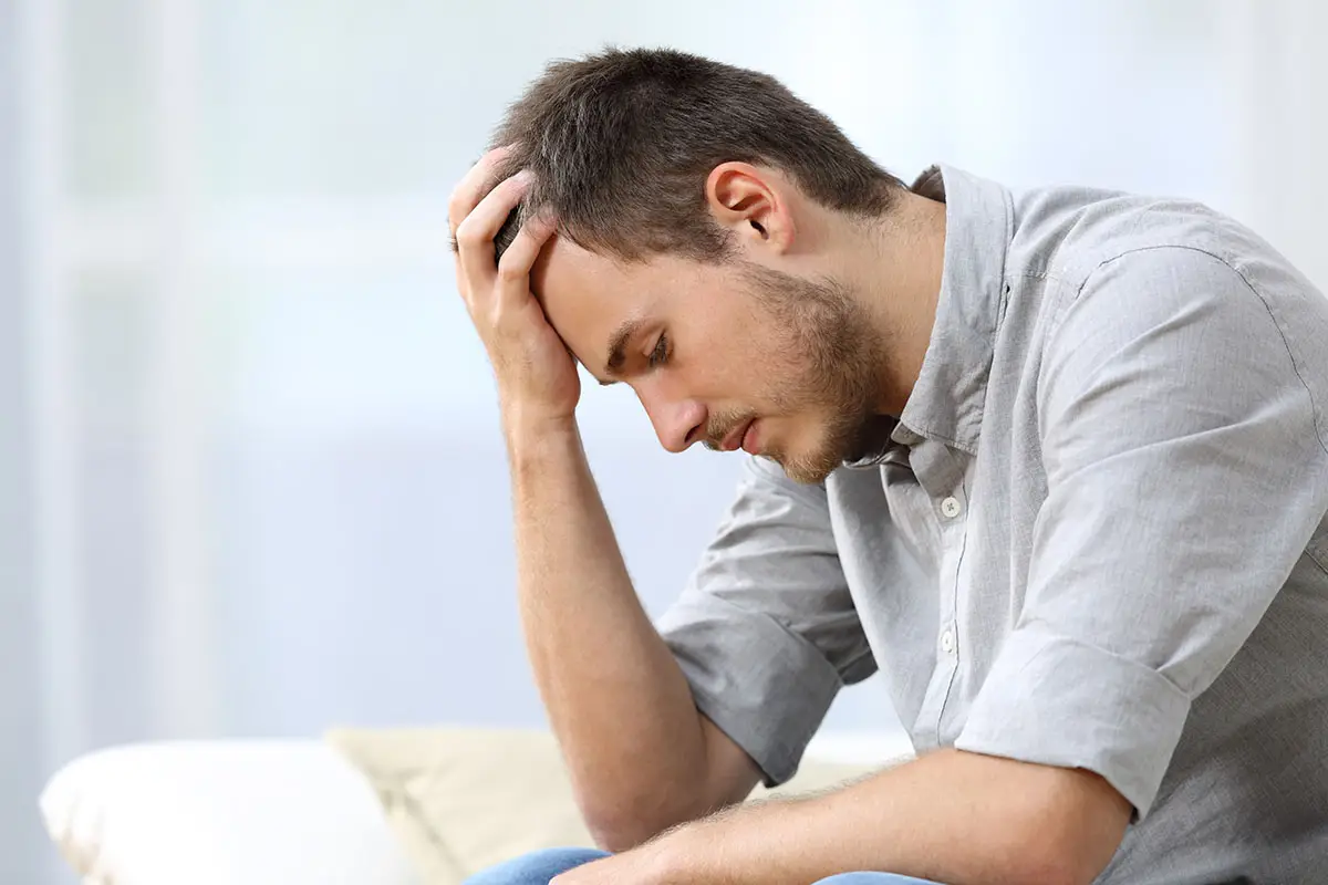 Man struggling with emotional distress and addiction before beginning detox treatment at Capo Beach Recovery in San Juan Capistrano, California.