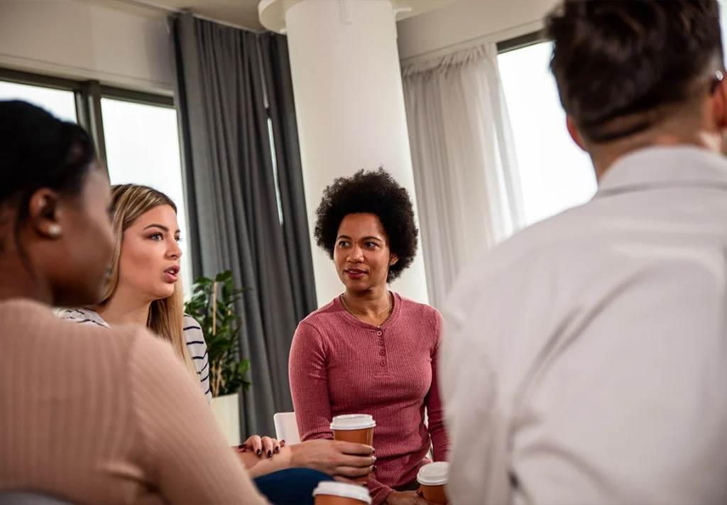 Group of people sharing experiences and supporting one another during addiction therapy at Capo Beach Recovery in San Juan Capistrano, California, highlighting compassionate and personalized recovery care.